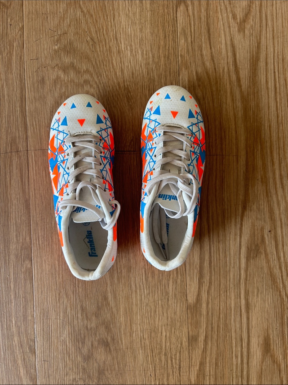 Kids' Soccer Cleats in White with Blue & Orange Accents